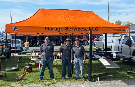 Garage Services team members in an outdoor booth